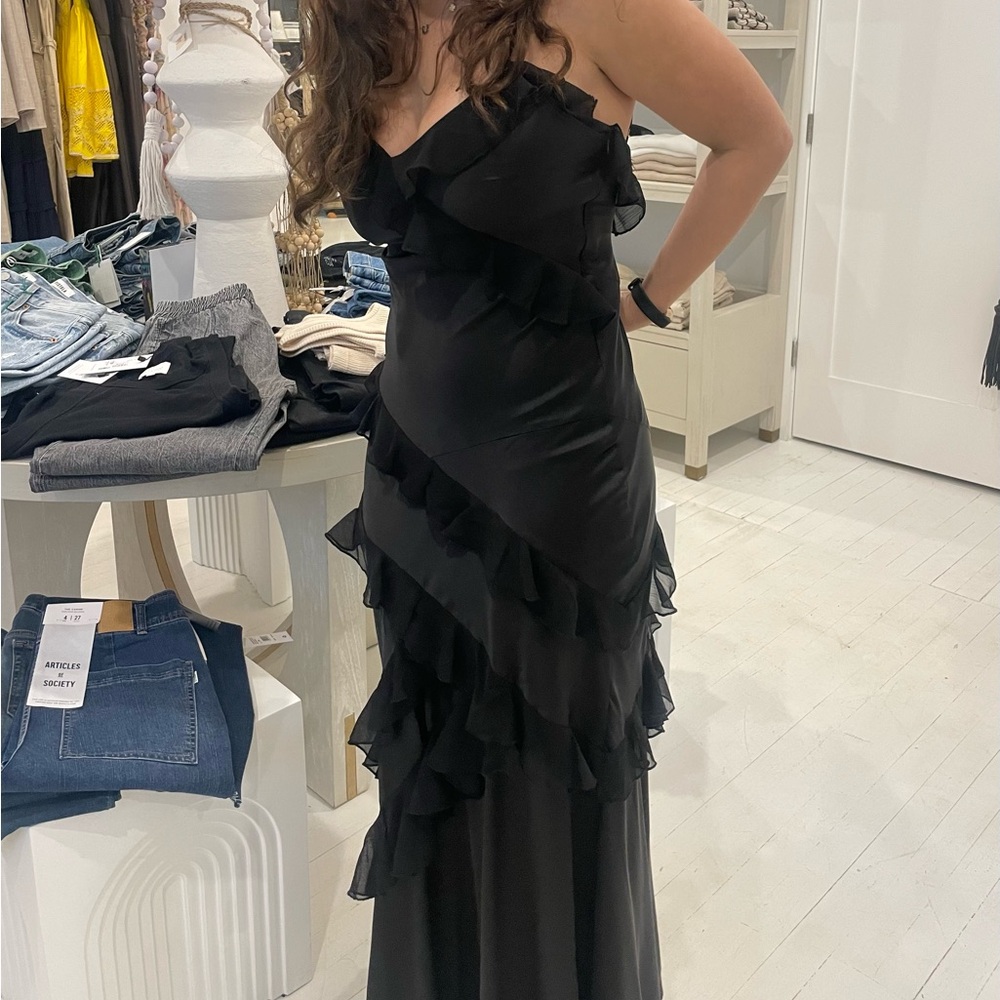Black satin tiered chiffon ruffle maxi with adjustable straps.⁩